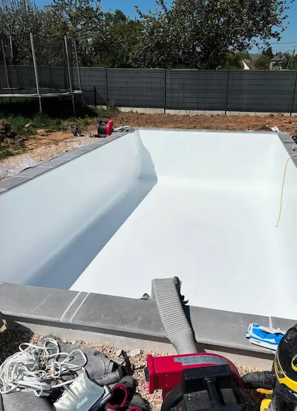 Piscine en cours de finition, bassin enduit blanc sur chantier — Île-de-France